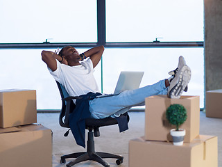 Image showing young black male architect taking a break on construction site
