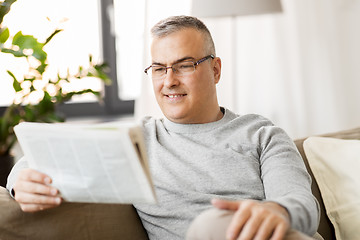 Image showing man reading newspaper at home