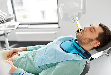 Image showing patient having x-ray scanning at dental clinic