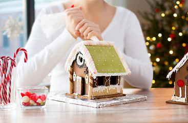 Image showing woman making gingerbread houses on christmas