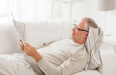 Image showing senior man reading newspaper at home