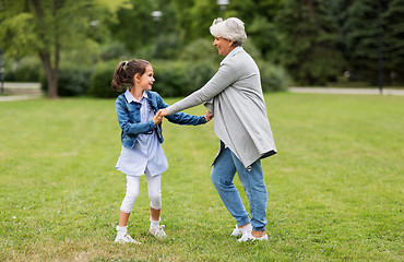 Image showing grandmother and granddaughter playing at park