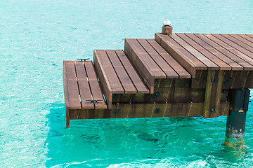 Image showing wooden pier with stair in sea water