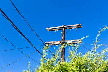 Image showing transmission tower and power line over blue sky