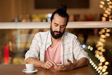 Image showing man with coffee and smartphone at restaurant