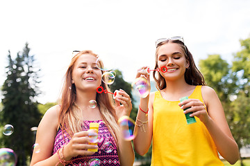 Image showing teenage girls blowing bubbles at summer park