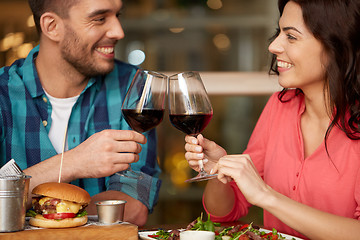 Image showing couple eating and drinking red wine at restaurant