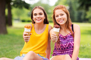 Image showing teenage girls eating ice cream at picnic in park