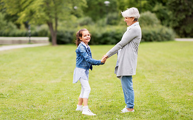 Image showing grandmother and granddaughter playing at park