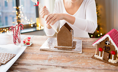 Image showing woman making gingerbread houses on christmas