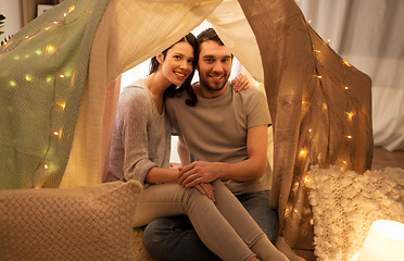 Image showing happy couple in kids tent at home