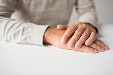 Image showing senior man hands on table