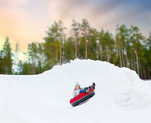 Image showing happy teenage girl sliding down hill on snow tube