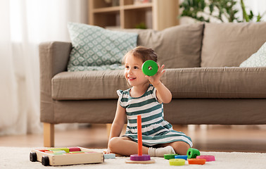 Image showing happy baby girl playing with toy blocks at home