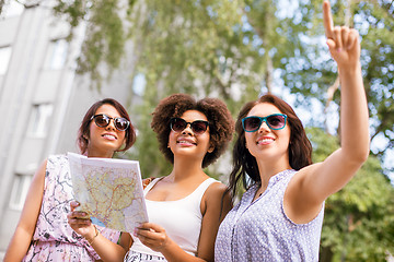 Image showing happy women with map on street in summer city