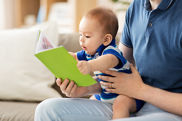 Image showing baby boy and father with book at home