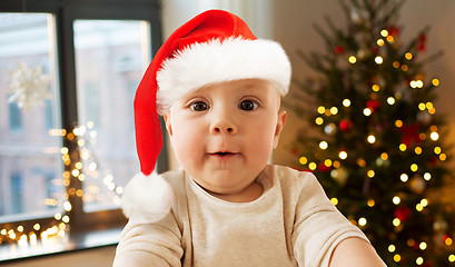 Image showing baby boy in santa hat taking selfie on christmas