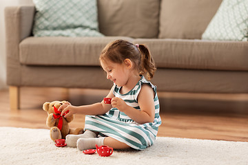 Image showing little girl playing with toy tea set at home