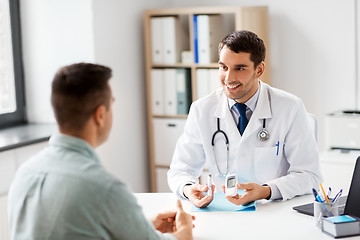 Image showing doctor with glucometer and patient at hospital