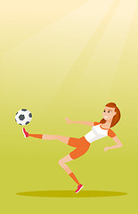 Image showing Young caucasian soccer player kicking a ball.