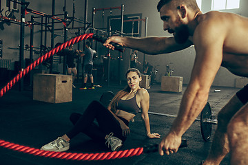 Image showing Men with battle rope battle ropes exercise in the fitness gym.