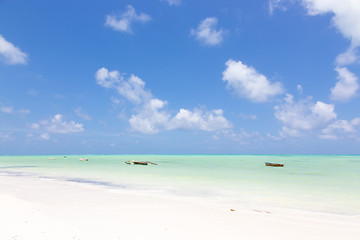 Image showing Traditional wooden fishing boats on picture perfect white sandy beach with turquoise blue sea, Paje, Zanzibar, Tanzania.