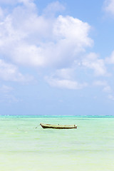 Image showing Fishing boat on picture perfect white sandy beach with turquoise blue sea, Paje, Zanzibar, Tanzania.