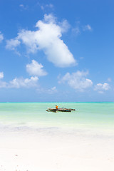 Image showing Fishing boat on picture perfect white sandy beach with turquoise blue sea, Paje, Zanzibar, Tanzania.