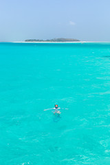 Image showing Woman snorkeling in clear shallow sea of tropical lagoon with turquoise blue water.