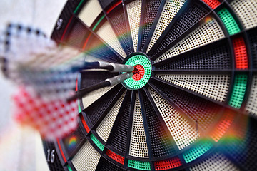 Image showing Darts arrow hitting in the target center