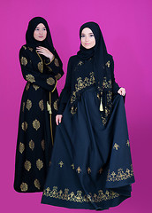 Image showing two hijab muslim woman on pink background