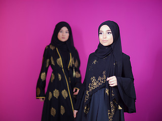 Image showing two hijab muslim woman on pink background