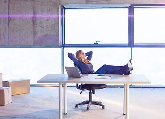 Image showing young female architect taking a break on construction site