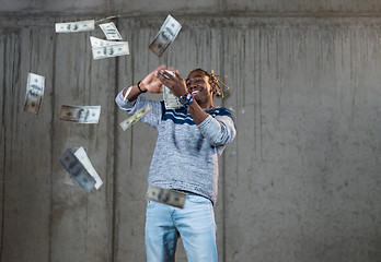 Image showing black businessman making the rain of money