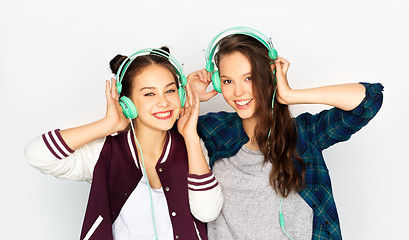 Image showing teenage girls in earphones listening to music