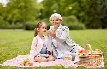 Image showing grandmother and granddaughter take selfie at park