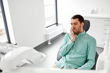 Image showing patient suffering from toothache at dental clinic