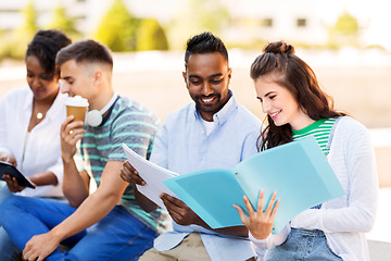 Image showing international students with notebooks outdoors