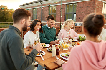 Image showing friends having dinner or rooftop party in summer