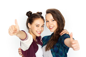 Image showing happy teenage girls hugging and showing thumbs up