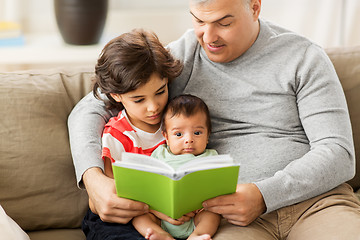 Image showing happy father with sons reading book at home