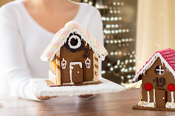 Image showing close up of woman with christmas gingerbread house