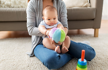 Image showing mother and baby son playing with ball at home