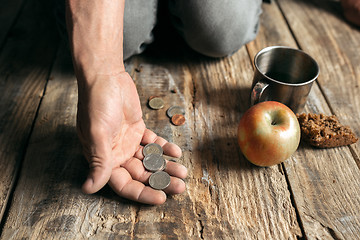 Image showing Male beggar hands seeking food or money at public path way