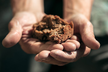 Image showing Male beggar hands seeking food or money at public path way