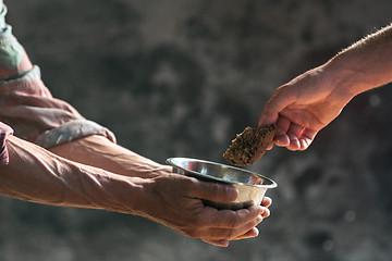 Image showing Male beggar hands seeking food or money at public path way