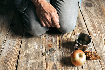 Image showing Male beggar hands seeking food or money at public path way