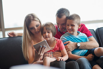 Image showing happy young couple spending time with kids