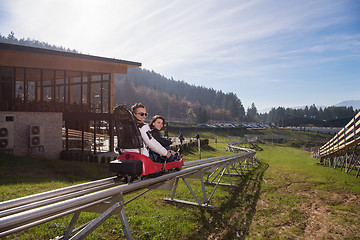 Image showing couple enjoys driving on alpine coaster