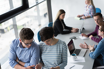 Image showing Two Business People Working With Tablet in office